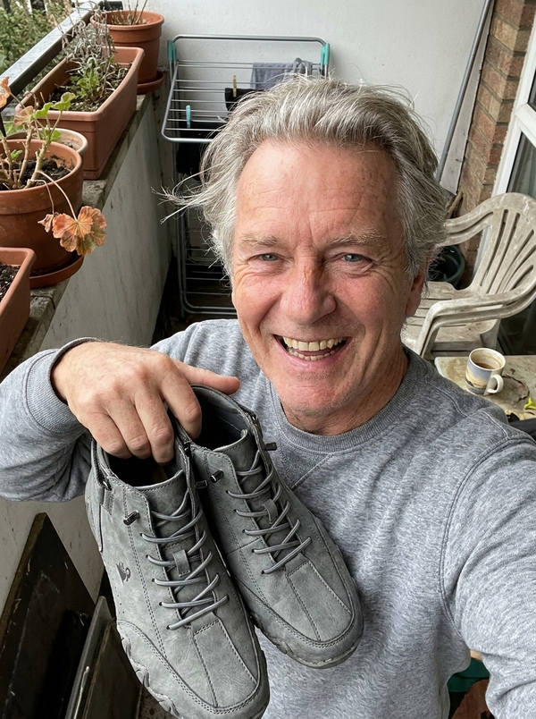 Customer photo — holding the FeetFlex pair on his balcony