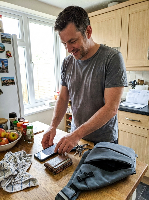 Customer photo — Vaultline bag on the kitchen table with keys, phone and wallet