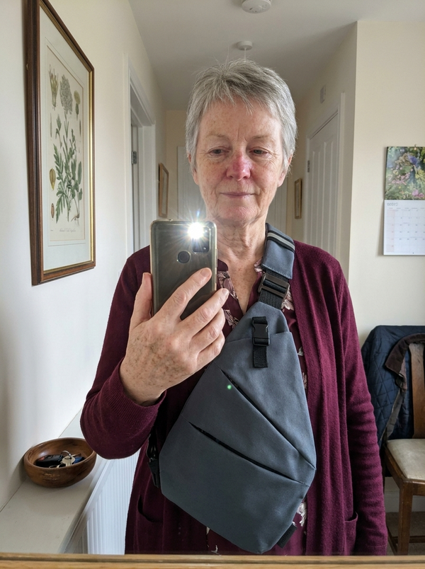 Customer photo — Vaultline bag worn across the chest, hallway mirror selfie